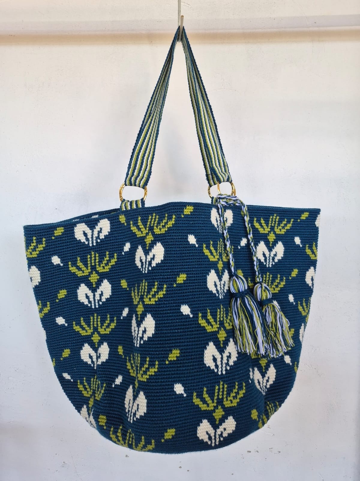 Totem Petróleo, bolso tejido a mano en crochet. Flores en marfil y lima sobre petróleo, tejidas a mano.
